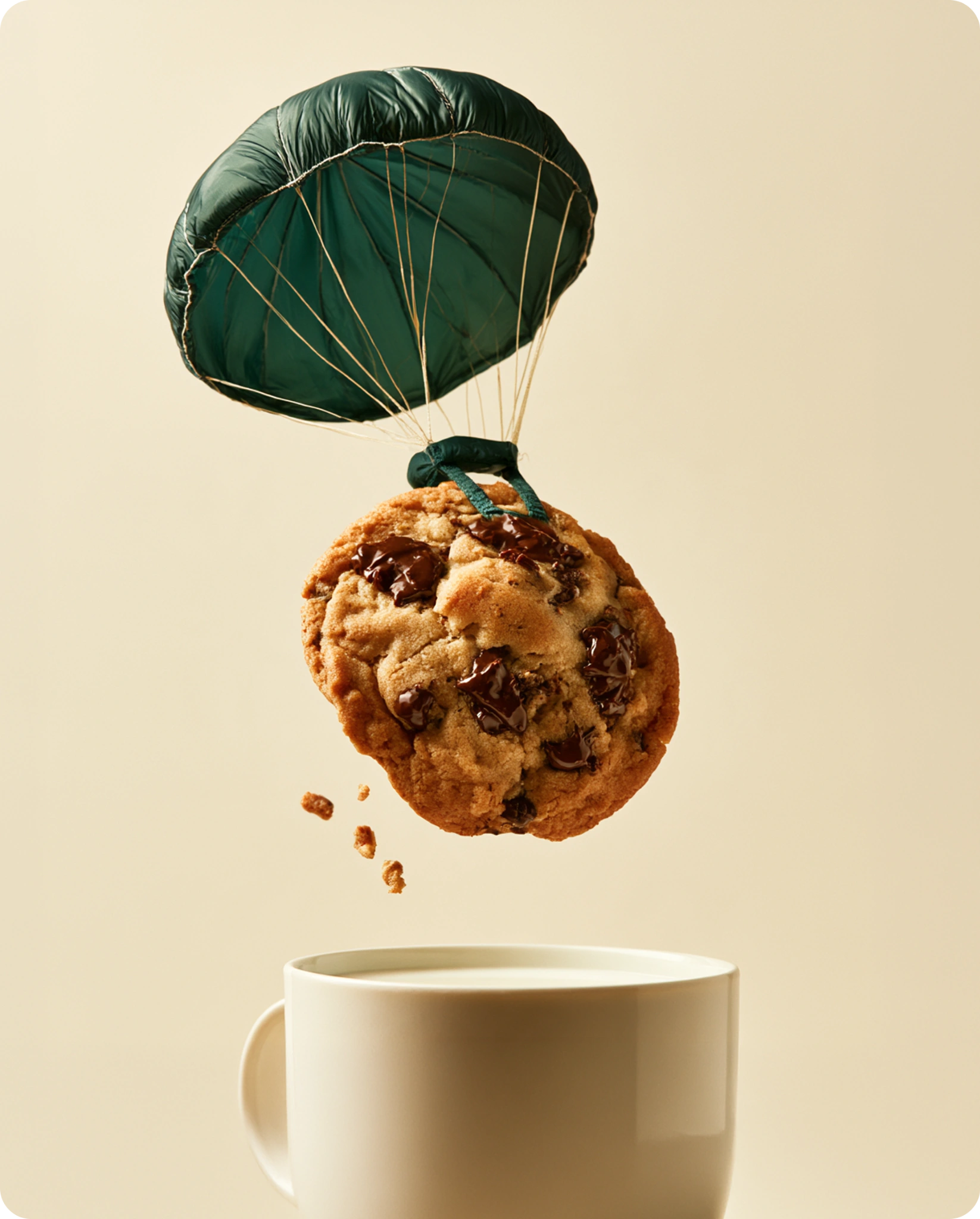 Un cookie descend en parachute vers un verre de lait.